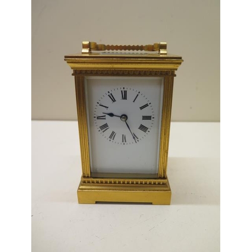 203 - An early 20th century gilt brass carriage clock, 16cm high including handle, running, glass good