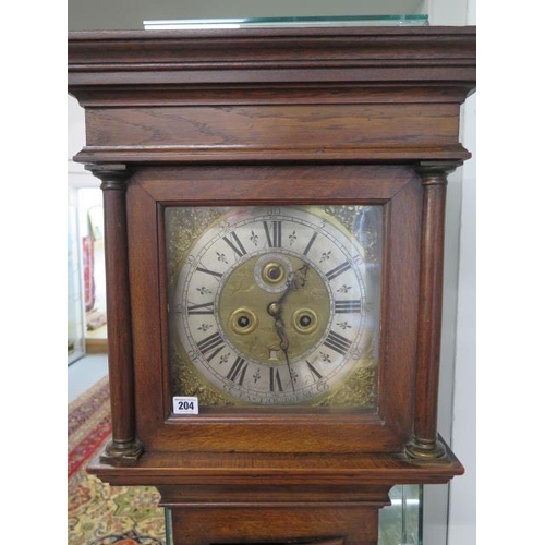 204 - An oak 8 day striking longcase clock with an 11