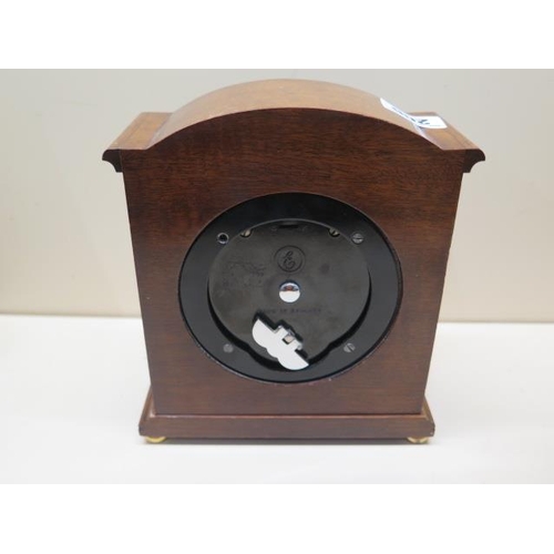 206 - An 8 day mantel clock by Elliott of London, 18cm tall, running