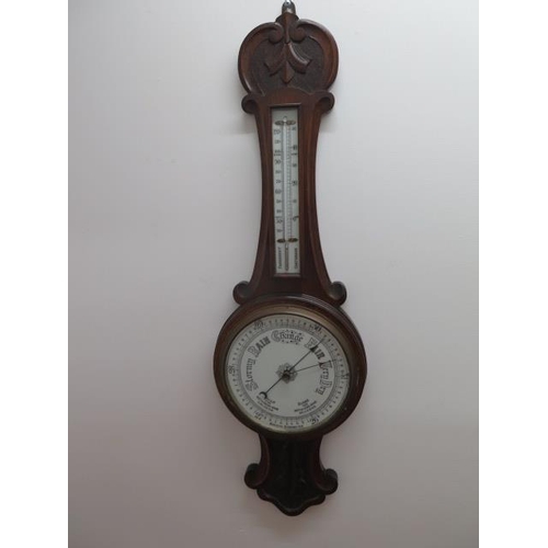 207 - An oak barometer with thermometer, 82cm tall