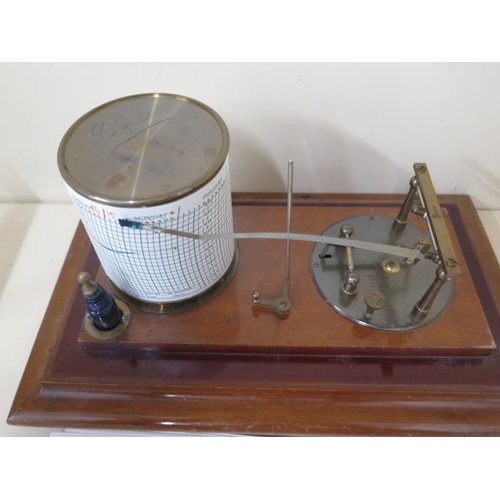 210 - A Tycos barograph retailed by Harrods Ltd Opticians London, 36cm x 22cm x 19cm tall, with spare char... 