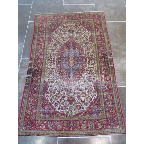 251 - A worn but decorative machine woven rug, 200cm x 128cm