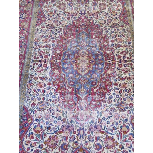 251 - A worn but decorative machine woven rug, 200cm x 128cm