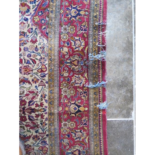 251 - A worn but decorative machine woven rug, 200cm x 128cm