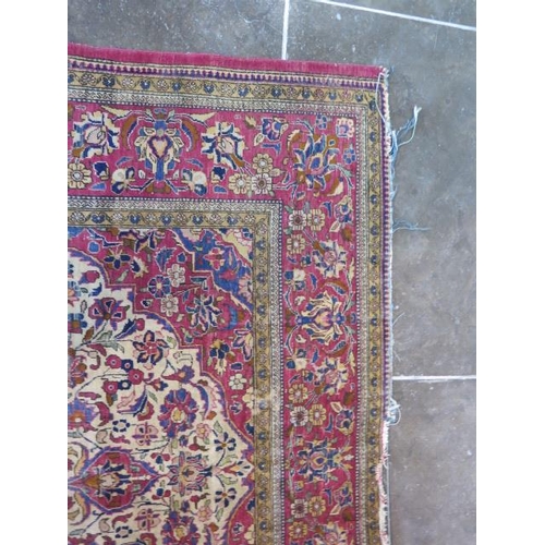 251 - A worn but decorative machine woven rug, 200cm x 128cm