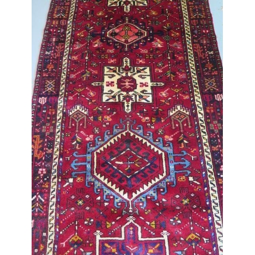 255 - A hand knotted woollen Karajeh rug, 3.05m x 1.15m, in good condition