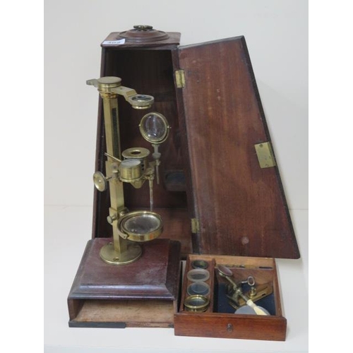 402 - A Georgian brass part microscope possibly Dolland but un named ,with various fittings housed in a ma... 