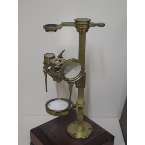 402 - A Georgian brass part microscope possibly Dolland but un named ,with various fittings housed in a ma... 