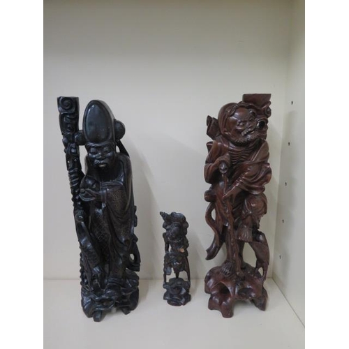 404 - Two Oriental carved rootwood figures, one with white metal inlay, 60cm  and 59cm tall, both with goo... 