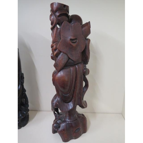 404 - Two Oriental carved rootwood figures, one with white metal inlay, 60cm  and 59cm tall, both with goo... 