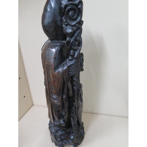 404 - Two Oriental carved rootwood figures, one with white metal inlay, 60cm  and 59cm tall, both with goo... 