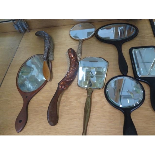 420 - A collection of 16 hand mirrors and brushes