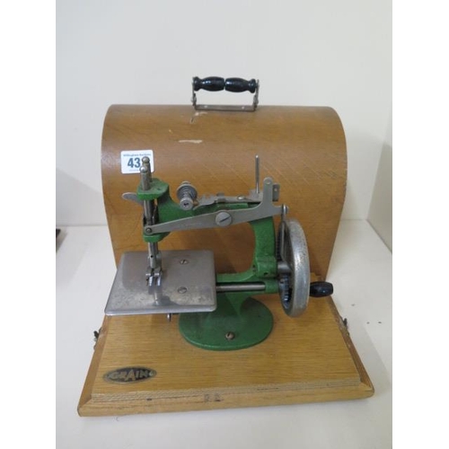 431 - A small sewing machine by Grain, working with case, measures 22cm tall