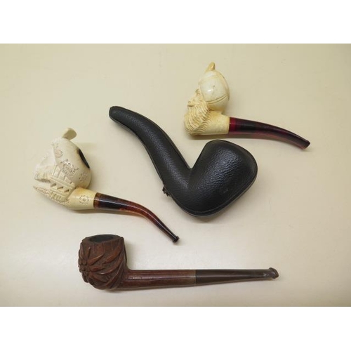 439 - A collection of four pipes to include two Meerschaum Turkish head pipes, a cased pierced reticulated... 