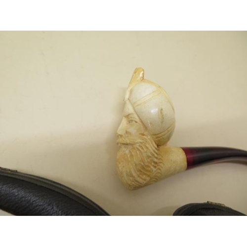 439 - A collection of four pipes to include two Meerschaum Turkish head pipes, a cased pierced reticulated... 