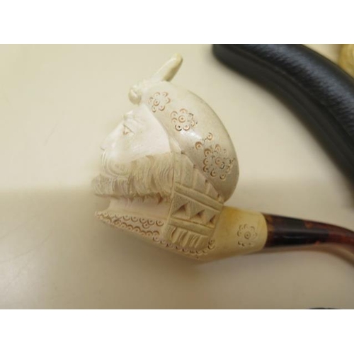 439 - A collection of four pipes to include two Meerschaum Turkish head pipes, a cased pierced reticulated... 