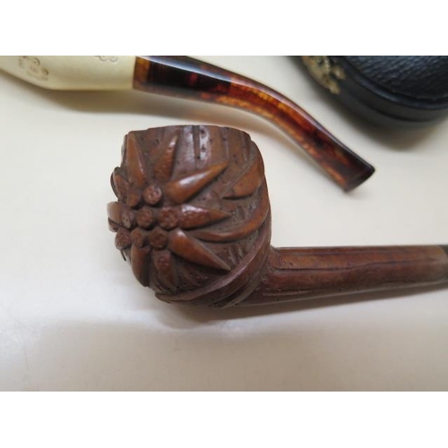 439 - A collection of four pipes to include two Meerschaum Turkish head pipes, a cased pierced reticulated... 