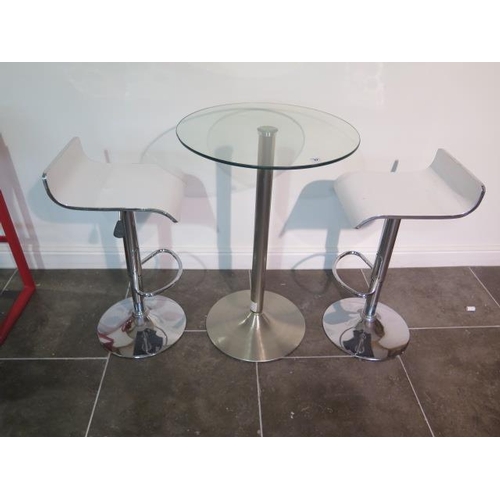 44 - A glass top bar table, 91cm tall x 60cm diameter with two white laminated gas lift stools, some usag... 