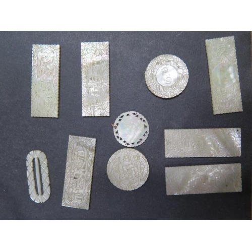 440 - A collection of nine 19th century Chinese mother of pearl gaming tokens and a buckle, all generally ... 