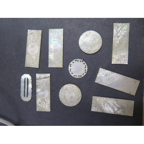 440 - A collection of nine 19th century Chinese mother of pearl gaming tokens and a buckle, all generally ... 