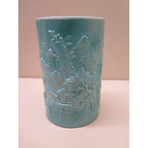 454 - A Chinese 19/20th century brush pot with a moulded landscape scene covered in a turquoise glaze, rai... 