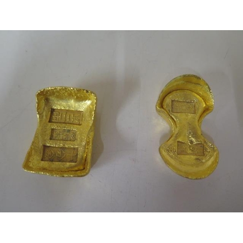 485 - Two gilded metal Chinese trade tokens, 5.5cm and 6.5cm long