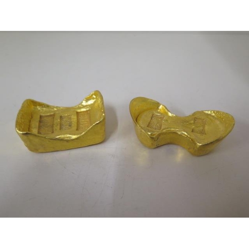 485 - Two gilded metal Chinese trade tokens, 5.5cm and 6.5cm long