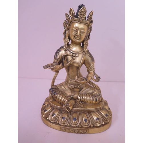 486 - A gilt bronze buddha, 20cm tall