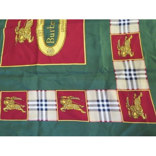 496 - A Burberrys silk scarf, c.1980, detailed with classic check and equestrian knight against a green gr... 