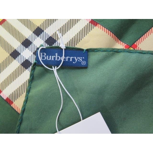 496 - A Burberrys silk scarf, c.1980, detailed with classic check and equestrian knight against a green gr... 