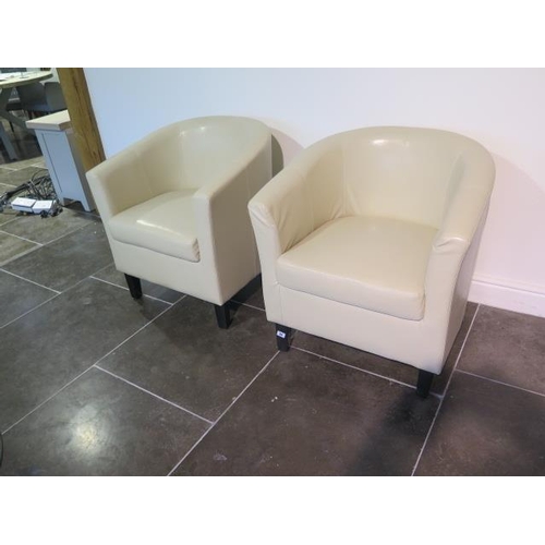 50 - A pair of faux leather cream tub chairs, some usage marks but generally good