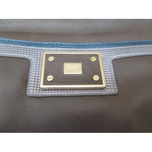 502 - A Anya Hindmarch brown, grey and blue leather bag with inside pockets, 40cm wide, some small amount ... 