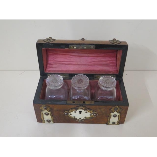 515 - A burr walnut Victorian dome top perfume casket with ormolu mounts containing three scent bottles, 1... 