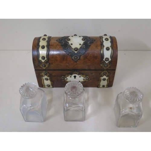 515 - A burr walnut Victorian dome top perfume casket with ormolu mounts containing three scent bottles, 1... 