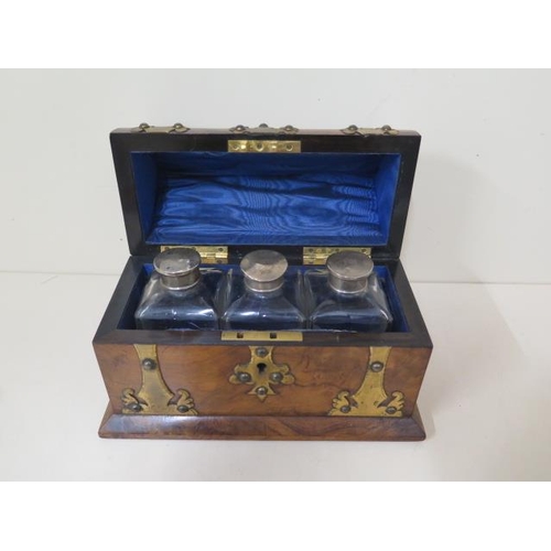 516 - A burr walnut Victorian steeple top perfume casket with brass mounts, lined interior, with three whi... 