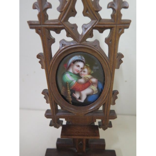 520 - A Victorian carved Black Forest carved icon with a hand painted Vienna porcelain plaque of the Madon... 