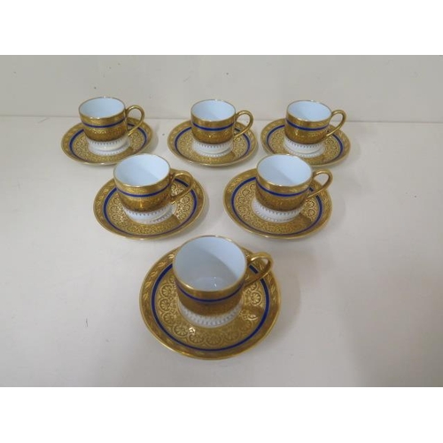 522 - A set of six gilt and blue Limoges coffee cans and saucers, all in good condition