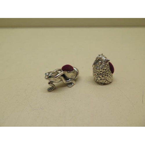 604 - A sterling silver owl pin cushion and a sterling silver frog with glass eyes towing a snail shell pi... 