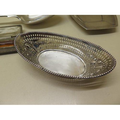 623 - A collection of silver. A pair of Victorian bonbon baskets, an Edwardian Chester wavy edged bowl, a ... 