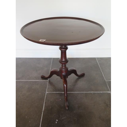 67 - A low mahogany tripod table, 60cm tall x 56cm diameter, in generally good condition