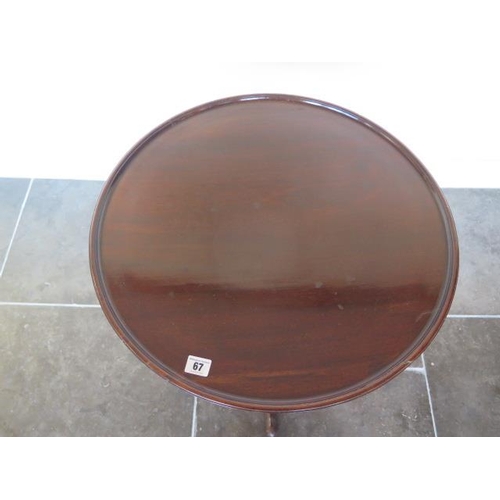 67 - A low mahogany tripod table, 60cm tall x 56cm diameter, in generally good condition