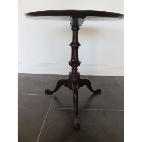 67 - A low mahogany tripod table, 60cm tall x 56cm diameter, in generally good condition