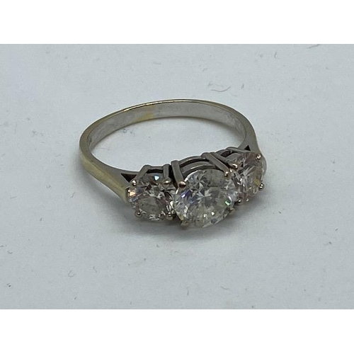 701 - An impressive 18ct white gold three stone diamond ring, the centre stone approx 1.9ct, side stones a... 