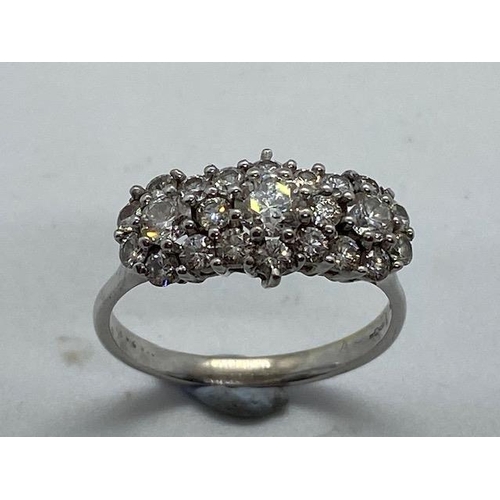 702 - A hallmarked 18ct white gold cluster ring, size W, approx 5.7 grams, in good condition with minor us... 