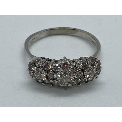 702 - A hallmarked 18ct white gold cluster ring, size W, approx 5.7 grams, in good condition with minor us... 