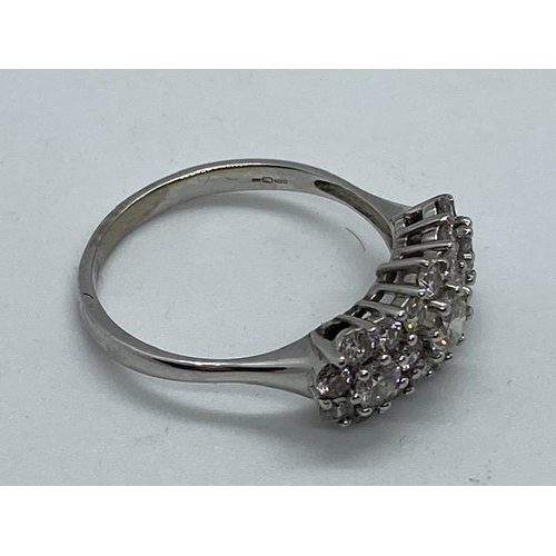 702 - A hallmarked 18ct white gold cluster ring, size W, approx 5.7 grams, in good condition with minor us... 