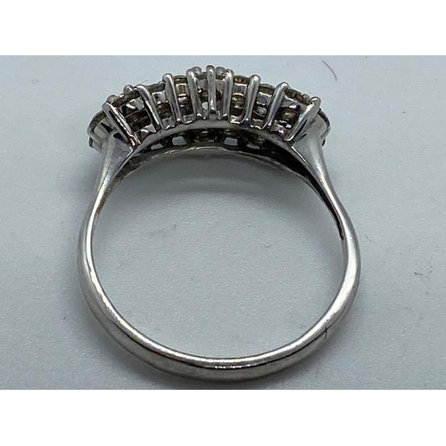 702 - A hallmarked 18ct white gold cluster ring, size W, approx 5.7 grams, in good condition with minor us... 