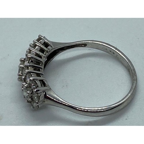 702 - A hallmarked 18ct white gold cluster ring, size W, approx 5.7 grams, in good condition with minor us... 