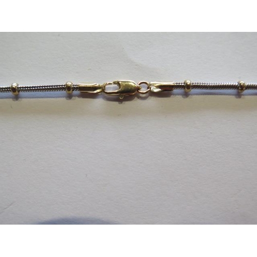 703 - A 9ct yellow and white gold necklet, 46cm long, approx 10 grams, in good condition and clasp working... 