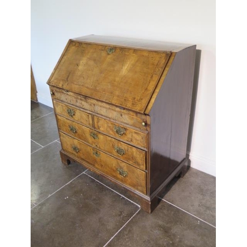 71 - A George 1st walnut bureau with a well and stepped fitted interior above two small and two long draw... 